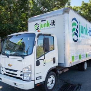 A junk-it atl truck on its way to haul away junk for a customer